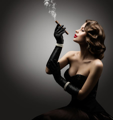 Wall Mural - retro woman smoking cigar, fashion model old fashioned beauty portrait over gray background