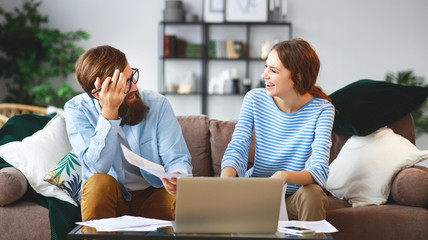 Wall Mural - married couple with bills receipts documents and laptop at home