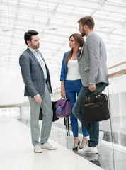 Wall Mural - group of young businessmen standing in a modern business center.