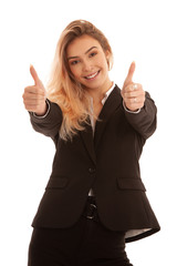 Beautiful young woman in black business suit gesture success with showing thumbs up isolated over white