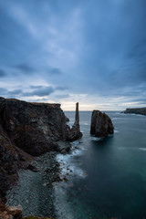 Beautiful seascape of a rocky Atlantic Ocean Coast during a cloudy sunrise. Taken in Spillars Cove, Bonavista, Newfoundland and Labrador, Canada.