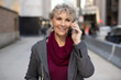 © blvdone - Mature woman in city walking talking on cell phone
