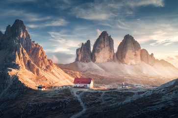 Wall Mural - mountain valley with beautiful house and church at sunset in autumn. landscape with buildings, high 