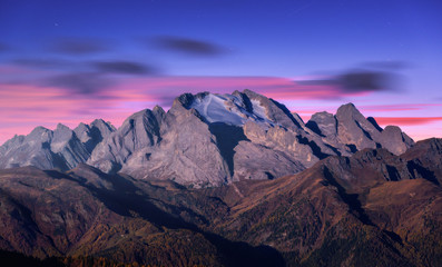 Wall Mural - mountain peak lighted by moonlight in autumn at night in dolomites, italy. beautiful landscape with 