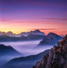 Wall Mural - mountains in fog at beautiful sunset in autumn in dolomites, italy. landscape with alpine mountain v