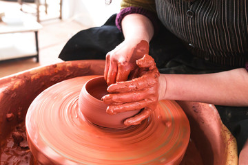 Professional potter making bowl in pottery workshop