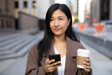 Canvas Print - Young Asian woman in city