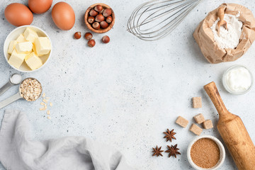 Wall Mural - Baking ingredients and utensils on concrete background. Cooking or baking cake, cookies, pastry or bread concept. Top view with copy space for text, recipe, menu