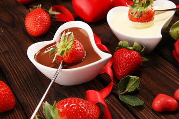 Wall Mural - Valentine Chocolate fondue melted with fresh strawberries and dark and white chocolate. Tublips and sugar hearts.