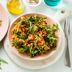 Wall Mural - rice salad with baked bell peppers, arugula, olives and capers. Healthy vegan spring recipe for the whole family or party