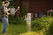 © Maria Sbytova - Outdoors portrait of little boy and his father.Kid and man having fun during gardening on the yard.