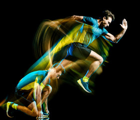Wall Mural - one caucasian runner running jogger jogging man light painting speed effect isolated on black backgr