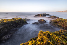 Amazing Las Brisas Beach An Awe Sea Coastline Landscape On A Wild Environment In Chile. The Sun Goes Down Over The Infinite Horizon While The Water Stream Push By The Waves Onto The Algae And Rocks