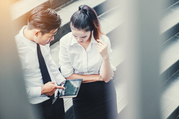 Asian business people meeting and using digital tablet outdoor after work