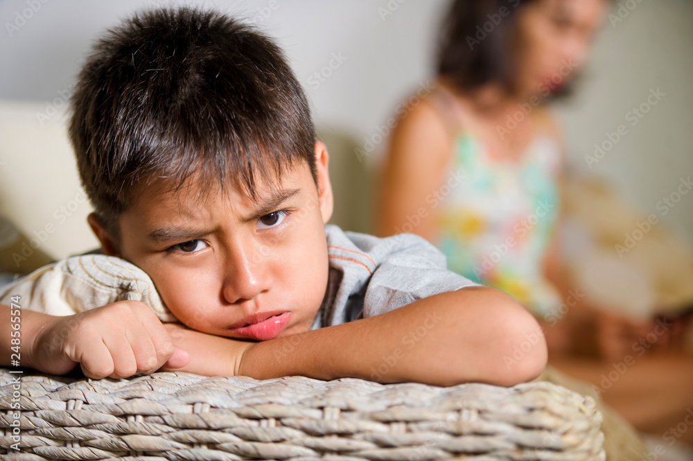 young sad and bored Asian child at home couch feeling frustrated and ...