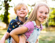© Rawpixel.com - Girl giving her brother a piggyback ride