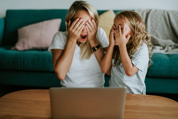 Mom and daughter watching a cartoon on a digital tablet