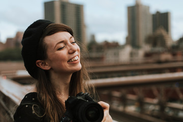 Photographer taking a photo at the Brooklyn Bridge, USA