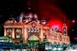 Flinders Street Station at night  with fireworks in the background