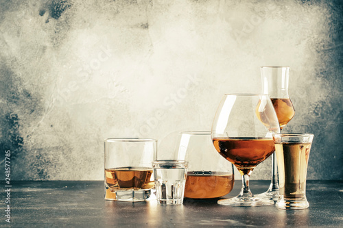 Fotomural Selection of hard strong alcoholic drinks in big glasses and small shot glass in assortent: vodka, cognac, tequila, brandy and whiskey, grappa, liqueur, vermouth, tincture, rum