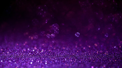 Purple glitter magic background. Defocused light and free focused place for your design.