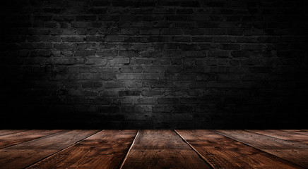 Wall Mural - background of an empty black room, a cellar, lit by a searchlight. Brick black wall and wooden floor