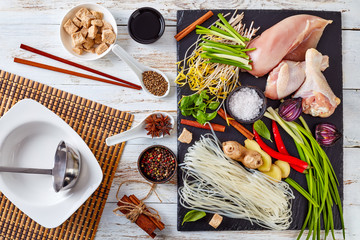 Wall Mural - raw ingredients for asian chicken soup, top view