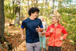 © Dusan Petkovic - Sporty smiling friends running in forest at autumn. Fitness outdoor concept.