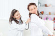 © yurolaitsalbert - little girl listens to her mother with a stethoscope