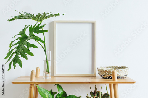 Fotomural Scandinavian room interior with mock up photo frame on the brown bamboo shelf with beautiful plants, tropical leafs and accessories