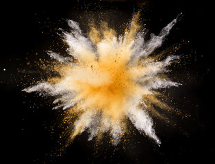 Wall Mural - Silver and gold powder explosion on black background. Freeze motion.