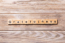 Gratefulness Word Written On Wood Block. Gratefulness Text On Wooden Table For Your Desing, Concept