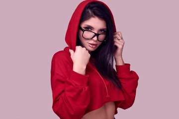 Wall Mural - Gorgeous brunette woman in fashion red hoodie in studio