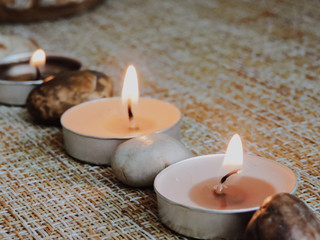 Spa treatments. Beautiful spa composition with  flowers on table close up. Spa still life with aromatic candles,candle background light  table relaxation spa beauty aromatherapy luxury closeup.