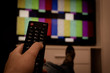 © julytis - Female holding TV remote control in front of TV. Couch potatoe. Point of view shot.