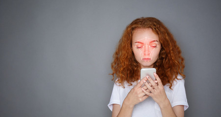 Attractive young woman with facial recognition system