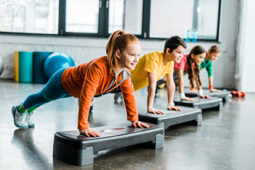 children doing plank exercise with step platforms