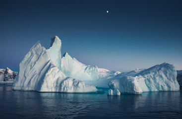 Wall Mural - close-up iceberg next to the antarctica shoreline. the huge ice covered mountain with the basin. the