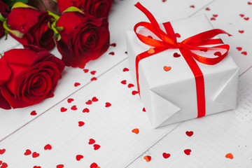 Wall Mural - St. Valentines Day. Red roses and gift box on wooden table