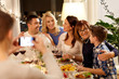 © Syda Productions - celebration, holidays and people concept - happy family having dinner party at home and taking selfie by smartphone