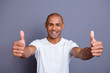 Close up photo strong healthy teeth dark skin he him his guy bald head approve show thumbs fingers up advise buy buyer new product wearing white t-shirt outfit clothes isolated grey background