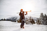 enjoying skiing at ski resort in mountains on a sunny winter day. Blue sky, ski lift, forest and people on the background - Image