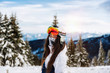 © Marko - Girl with ski mask and snowboard on the background of snow-capped mountains enjoying a sunny winter day. Idyllic landscape winter vacations adventure lifestyle. Alpine skiing active holidays. - Image
