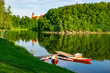Boats moored on Lesna lake near Czocha Castle at sunny summer morning , Lower Silesia, Poland