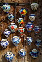 A Lot Of Colorful Handmade Jugs Pots Hanging On A Wooden Board In A Souveniers Shop In Frigiliana