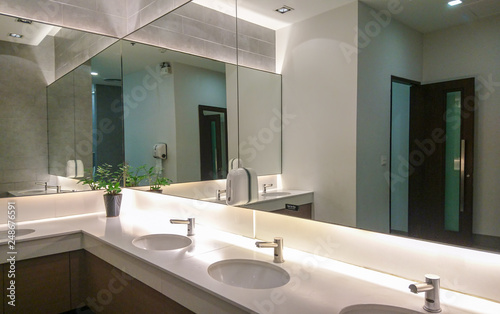 Cuadros en Lienzo Faucets with washbasin and big mirror
