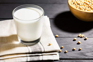 Wall Mural - Healthy glass of soymilk and soyseeds in a bowl.