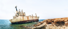 Old Damaged Rusty Transportation Ship After Crash  On The Coastline.