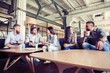 © opolja - Successful young business people are talking and smiling during the coffee break in office.