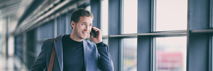 Wall Mural - Business man talking on phone walking in airport using smartphone 5g tech device banner panorama - young businessman commute lifestyle panoramic background.